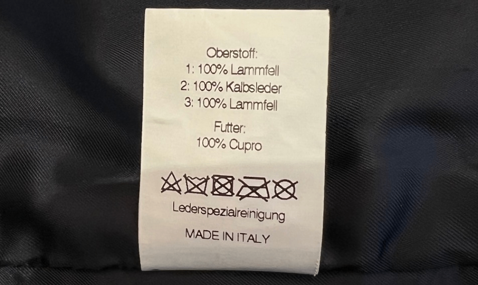Pre-Loved Aigner Lammfellmantel mit Lederärmeln und Lammfellkragen